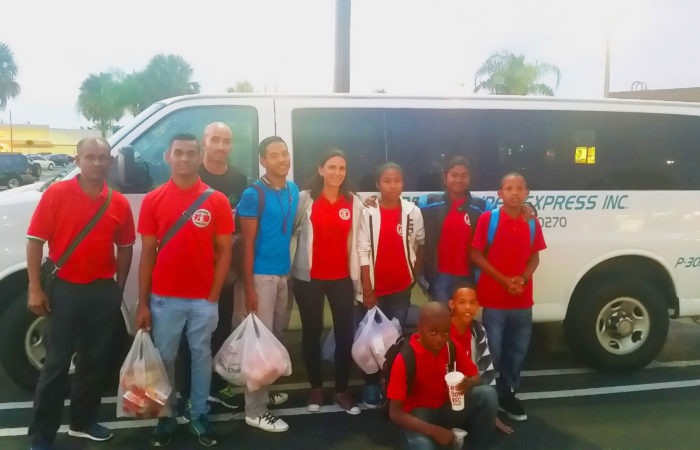 People standing in front of an Airport Super Express van