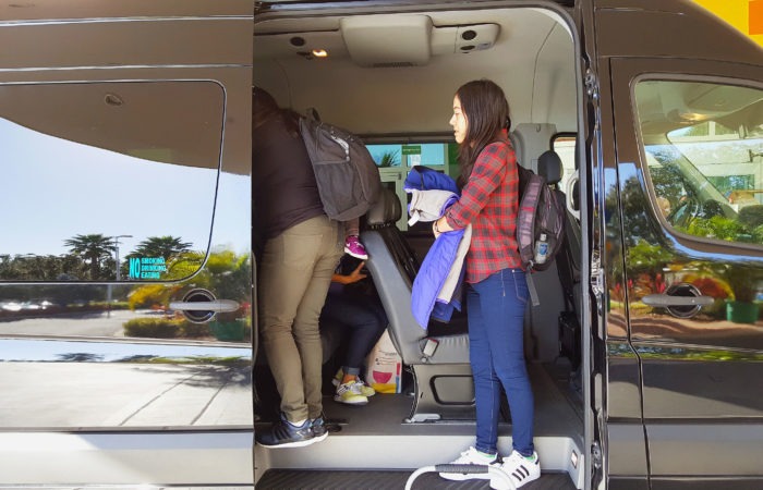 People loading into an Airport Super Express van